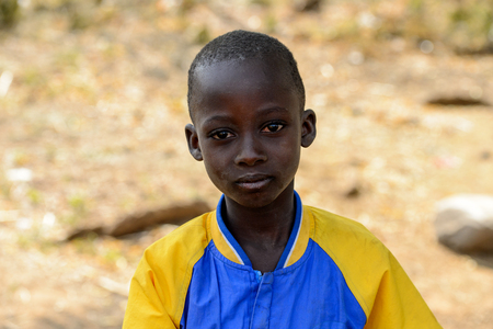 GHANI, GHANA - JAN 14, 2017: Unidentified Ghanaian little boy looks ahead in the Ghani village. Ghana children suffer of poverty due to the bad economy.のeditorial素材