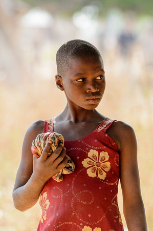GHANI, GHANA - JAN 14, 2017: Unidentified Ghanaian girl looks away in the Ghani village. Ghana children suffer of poverty due to the bad economy.のeditorial素材
