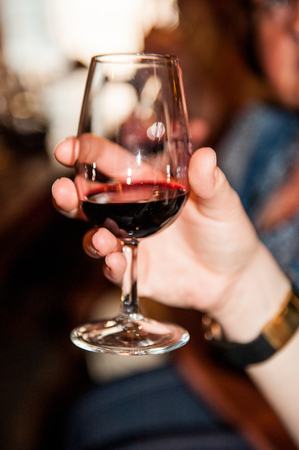 PORTO, PORTUGAL - JUN 21, 2014: Glass of the port wine of the Calem trademark. Calem company was created in 1859 and now it's one of the world brands of the port wines from Portoのeditorial素材