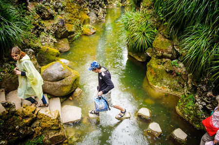 SINTRA, PORTUGAL - JUN 22, 2014: Unidentified boy crosses the Waterfall lake of the Quinta da Regaleira estate, Sintra,Portugal. Quinta da Regaleira is a UNESCO World heritage siteのeditorial素材