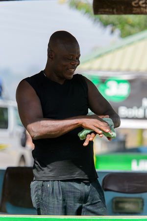 BRONG AHAFO, GHANA - JAN 15, 2017: Unidentified Ghanaian man holds a rag in his hands. Ghana people suffer of poverty due to the bad economy.のeditorial素材