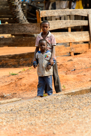 TECHIMAN, GHANA - JAN 15, 2017: Unidentified Ashanti boys stand in the local village. Ashante are ethnic group of Ghanaのeditorial素材