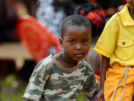 TECHIMAN, GHANA - JAN 15, 2017: Unidentified Ashanti boy in militay shirt looks ahead in the local village. Ashante are ethnic group of Ghanaのeditorial素材
