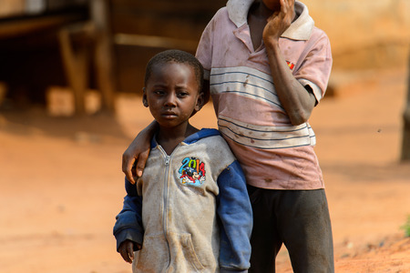 TECHIMAN, GHANA - JAN 15, 2017: Unidentified Ashanti little boy in dirty clothes looks away in the...
