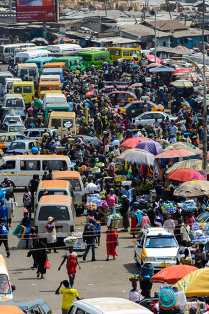 KUMASI, GHANA - JAN 15, 2017: Unidentified Ghanaian people walk at the Kumasi market. Ghana people...