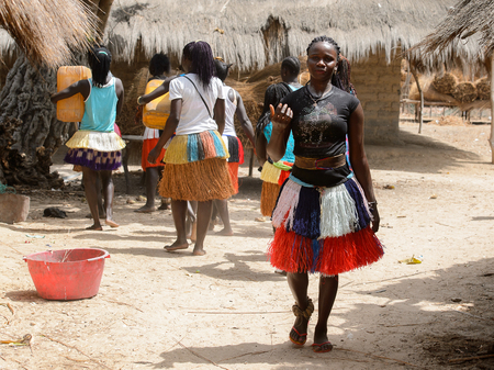 ORANGO ISL., GUINEA BISSAU - MAY 3, 2017: Unidentified local Women in straw skirts dance  during Vaca Bruto, traditional Mask danceのeditorial素材