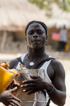 ORANGO ISL., GUINEA BISSAU - MAY 3, 2017: Unidentified local A man knocks on a canister during Vaca Bruto, traditional Mask danceのeditorial素材
