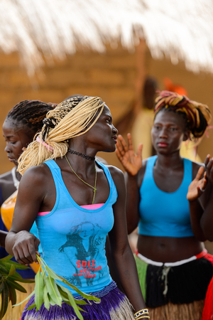 ORANGO ISL., GUINEA BISSAU - MAY 3, 2017: Unidentified local Women in straw skirts clap their hands and dance during Vaca Bruto, traditional Mask danceのeditorial素材