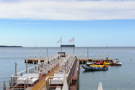 CANNES, FRANCE - JUNE 25, 2014: Beach of the Majestic Barriere hotel on the Mediterranean Sea, Cote d'Azur, Cannes. Cannes hosts the annual Cannes Film festival from 1949のeditorial素材