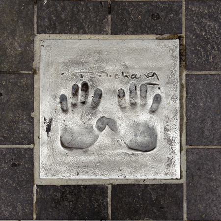 CANNES, FRANCE - JUN 25, 2014: Pierre Richard (French comedian) hand mark on the alley of fame in...