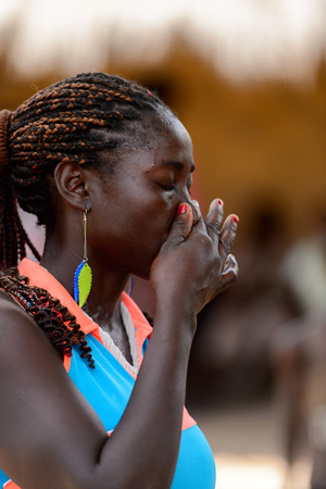 ORANGO ISL., GUINEA BISSAU - MAY 3, 2017: Unidentified local The girl holds her nose during Vaca Bruto, traditional Mask danceのeditorial素材