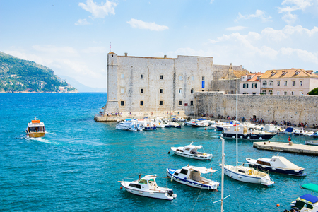 DUBROVNIK, CROATIA - AUG 21, 2014: Boats at the harbour of the Old town of Dubrovnik, Croatia. Dubrovnik is a UNESCO World Heritage siteのeditorial素材