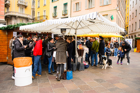 LUGANO, SWITZERLAND - DEC 24, 2014: Unidentified people on the Christmas market in the centre of Lugano. Christmas markets   started from the Late Middle Ages in  Germany, Austriaのeditorial素材