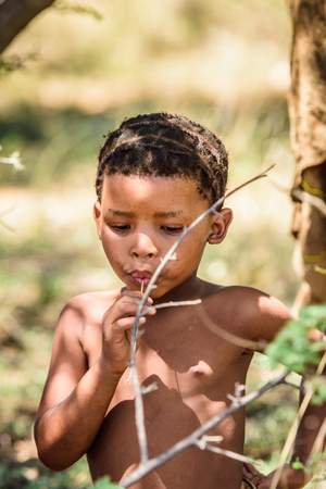 EAST OF WINDHOEK, NAMIBIA - JAN 3, 2016: Unidentified bushman little boy. Bushman people are members of various indigenous hunter-gatherer people of Southern Africaのeditorial素材