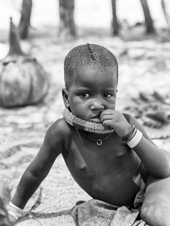 KAMANJAB, NAMIBIA - SEPTEMBER 07, 2015: Unidentified little boy  from Himba tribe. The Himba are indigenous people living in northern Namibia and Angolaのeditorial素材