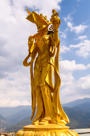 Golden statue around the Big Buddha statue in the Kingdom of Bhutanの写真素材