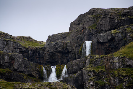 Little waterfall Klifbrekkufossar in Mjoifjordur, Icelandの写真素材