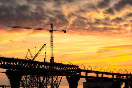 Bridge under construction in Russia on the Sunset over the sea in Russiaの写真素材