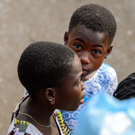 ACCRA, GHANA - JAN 8, 2017: Unidentified Ghanaian beautiful girls in colored dresses wear earings. Children of Ghana suffer of poverty due to the economic situationのeditorial素材