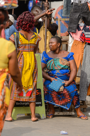 LOME, TOGO - Jan 9, 2017: Unidentified Togolese group of women in colored dresses at the Lome central market. Togo people suffer of poverty due to the bad economyのeditorial素材