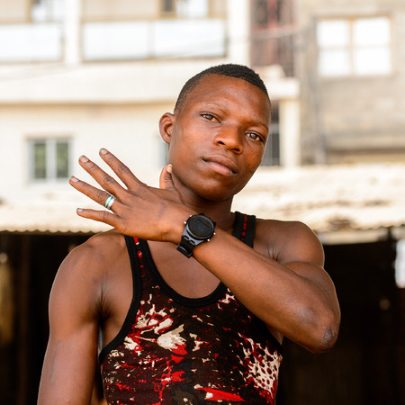 LOME, TOGO - Jan 9, 2017: Unidentified Togolese boy shows his watches at the Lome fetish market. Togo people suffer of poverty due to the bad economyのeditorial素材
