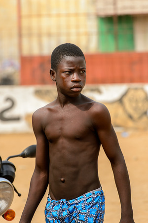 LOME, TOGO - Jan 9, 2017: Unidentified Togolese topless young boy turns around at the Lome fetish market. Togo people suffer of poverty due to the bad economyのeditorial素材