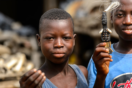 LOME, TOGO - Jan 9, 2017: Unidentified Togolese boy holds out his hand at the Lome fetish market. Togo people suffer of poverty due to the bad economyのeditorial素材