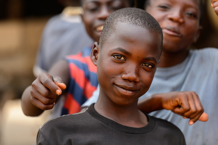 LOME, TOGO - Jan 9, 2017: Unidentified Togolese boy in black shirt smiles at the Lome fetish market....