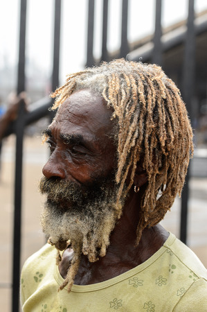 LOME, TOGO - Jan 9, 2017: Unidentified Togolese man with beard and dreads at the Lome port. Togo people suffer of poverty due to the bad economyのeditorial素材
