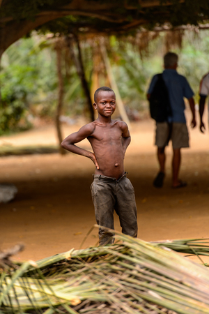 LOME, TOGO - Jan 9, 2017: Unidentified Togolese young topless boy puts his hands on his hips. Togo people suffer of poverty due to the bad economyのeditorial素材