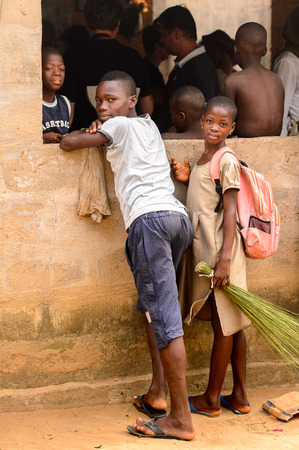 LOME, TOGO - Jan 9, 2017: Unidentified Togolese people stand near the local shaman's house. Togo people suffer of poverty due to the bad economyのeditorial素材