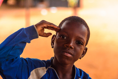 OUIDAH, BENIN - Jan 9, 2017: Unidentified Beninese boy puts his hand to his temple. Benin children suffer of poverty due to the bad economyのeditorial素材
