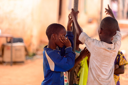 OUIDAH, BENIN - Jan 9, 2017: Unidentified Beninese boys play outside. Benin children suffer of poverty due to the bad economyのeditorial素材