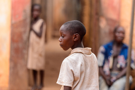 OUIDAH, BENIN - Jan 9, 2017: Unidentified Beninese boy in beige shirt closes his eyes. Benin children suffer of poverty due to the bad economyのeditorial素材