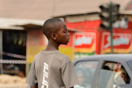 ACCRA, GHANA - Jan 8, 2017: Unidentified Ghanaian boy in beige shirt looks away. People of Ghana suffer of poverty due to the economic situationのeditorial素材