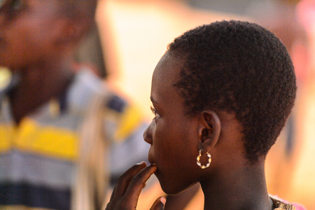 OUIDAH, BENIN - Jan 9, 2017: Unidentified Beninese girl wears earing. Benin children suffer of poverty due to the bad economyのeditorial素材