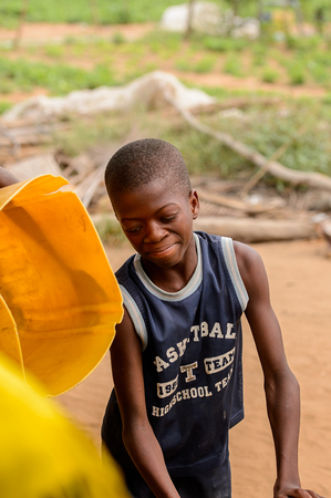 LOME, TOGO - Jan 9, 2017: Unidentified Togolese young boy in black shirt smiles. Togo people suffer of poverty due to the bad economyのeditorial素材