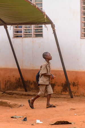 OUIDAH, BENIN - Jan 9, 2017: Unidentified Beninese boy walks in the street. Benin children suffer of poverty due to the bad economyのeditorial素材