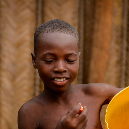 LOME, TOGO - Jan 9, 2017: Unidentified Togolese young boy smiles. Togo children suffer of poverty due to the bad economyのeditorial素材