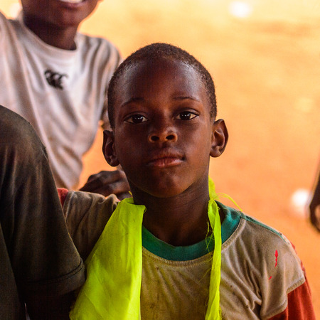 OUIDAH, BENIN - Jan 9, 2017: Unidentified Beninese boy in dirty clothes. Benin children suffer of poverty due to the bad economyのeditorial素材