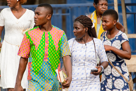 ACCRA, GHANA - Jan 8, 2017: Unidentified Ghanaian group of people stand on the street. People of Ghana suffer of poverty due to the economic situationのeditorial素材