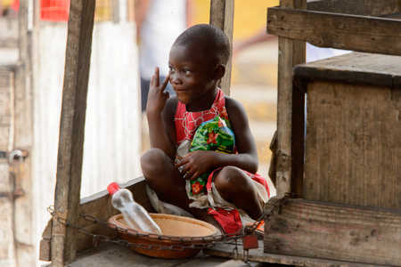ACCRA, GHANA - Jan 8, 2017: Unidentified Ghanaian boy shows three fingers at the local market. People of Ghana suffer of poverty due to the economic situationのeditorial素材