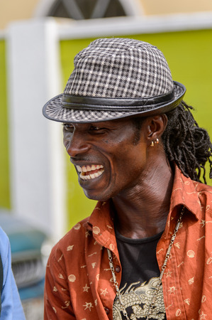 ACCRA, GHANA - Jan 8, 2017: Unidentified Ghanaian man in plaid hat smiles at the local market. People of Ghana suffer of poverty due to the economic situationのeditorial素材
