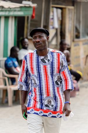 ACCRA, GHANA - Jan 8, 2017: Unidentified Ghanaian man walks at the local market. People of Ghana suffer of poverty due to the economic situationのeditorial素材