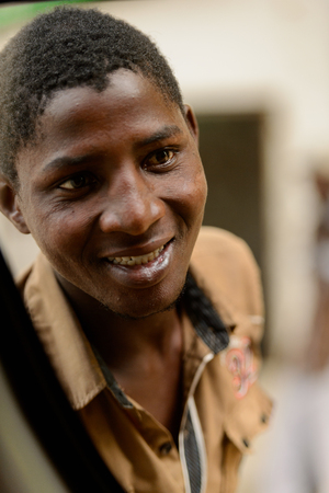 LOME, TOGO - Jan 9, 2017: Unidentified Togolese man smiles. Togo people suffer of poverty due to the bad economyのeditorial素材