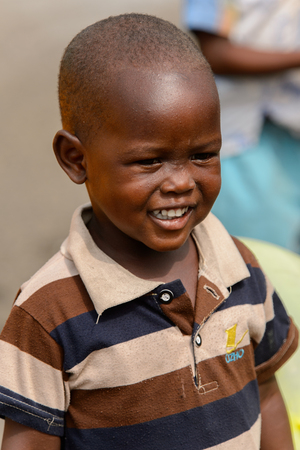 ACCRA, GHANA - Jan 8, 2017: Unidentified Ghanaian boy smiles at the local market. People of Ghana suffer of poverty due to the economic situationのeditorial素材