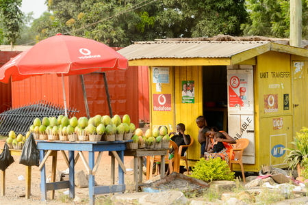 ACCRA, GHANA - Jan 8, 2017: Unidentified Ghanaian woman with her children sells some fruits on the street. People of Ghana suffer of poverty due to the economic situationのeditorial素材
