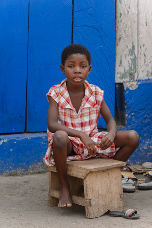 ACCRA, GHANA - Jan 8, 2017: Unidentified Ghanaian  little boy in plaid shirt at the local market. Children of Ghana suffer of poverty due to the economic situationのeditorial素材