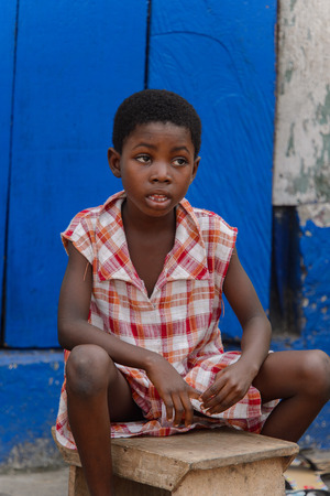 ACCRA, GHANA - Jan 8, 2017: Unidentified Ghanaian  little boy in plaid shirt at the local market. Children of Ghana suffer of poverty due to the economic situationのeditorial素材