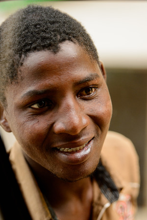 LOME, TOGO - Jan 9, 2017: Unidentified Togolese man smiles. Togo people suffer of poverty due to the bad economyのeditorial素材